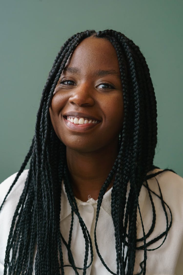 Smiling Black Model With Afro Braids On Gray Background