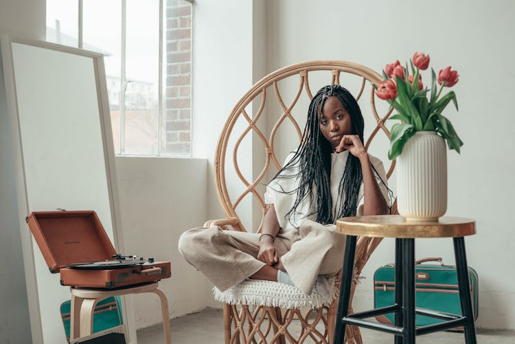 Tranquil Young Black Woman Listening To Songs Via Vinyl Record At Home