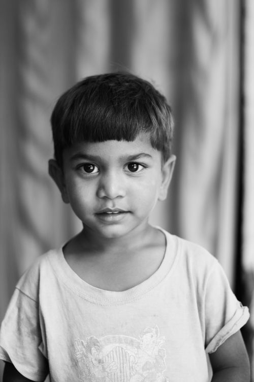 Free Adorable portrait of a young boy in grayscale, capturing innocence and emotion. Stock Photo