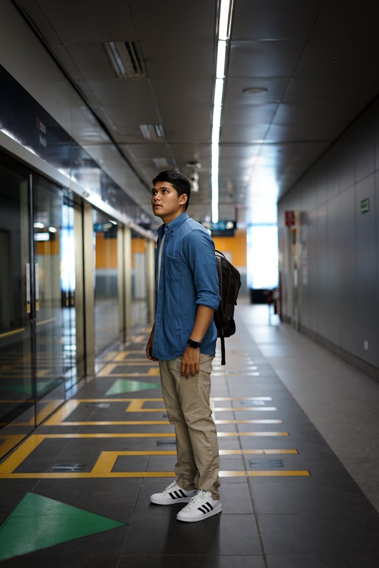 Man With Backpack Standing In Airport