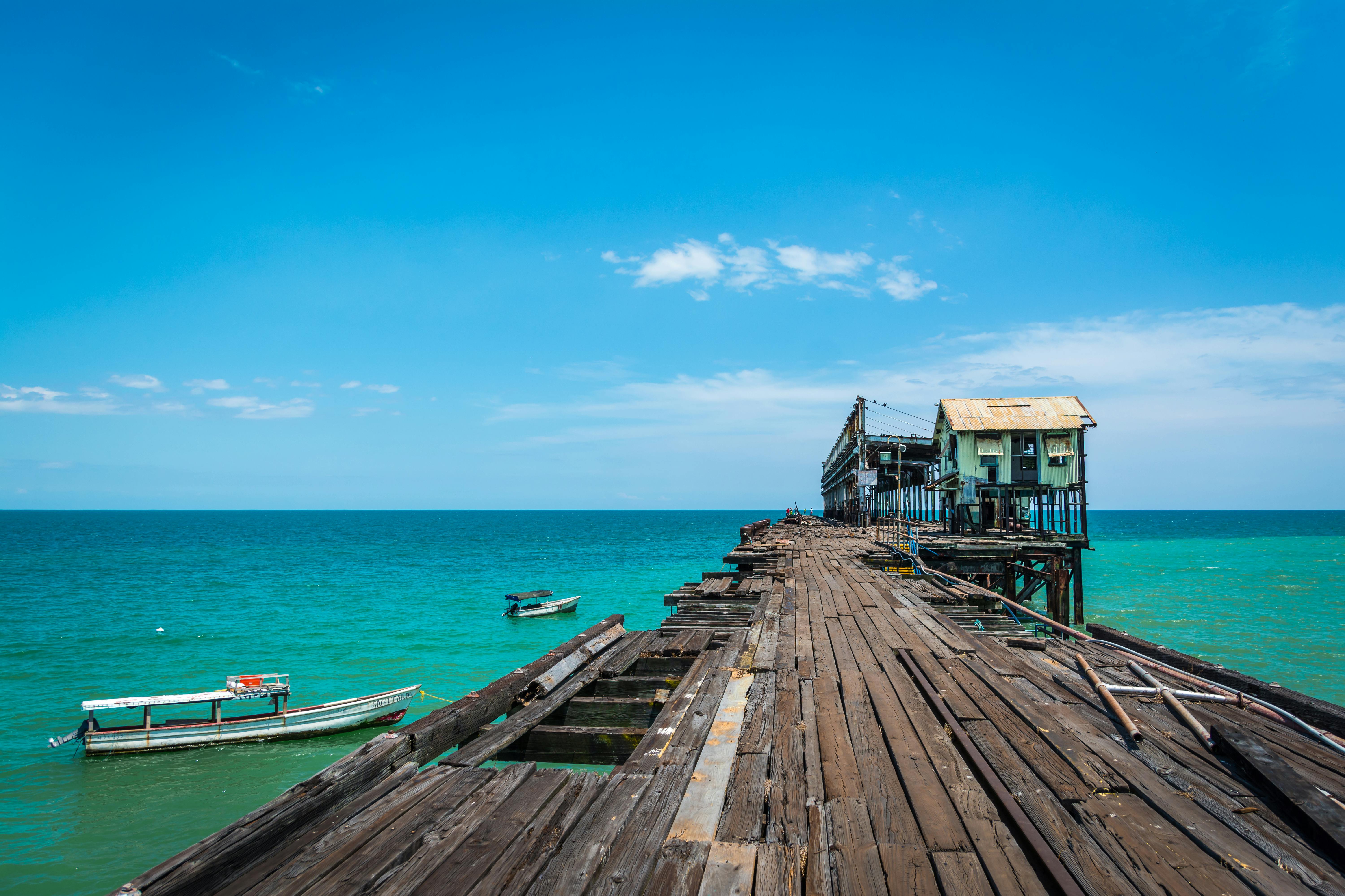 Boat Docked On The Sand At The Ocean Stock Photo - Download Image