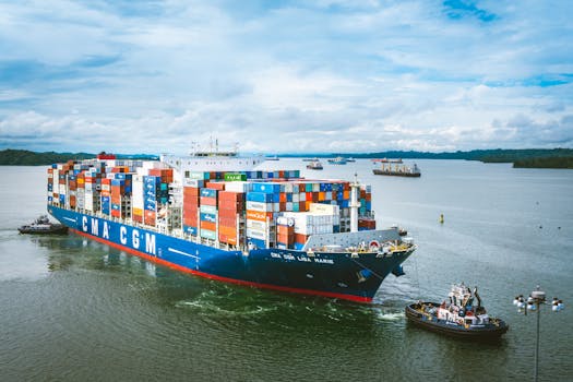 Large cargo ship transporting goods through Panama Canal on a clear day.