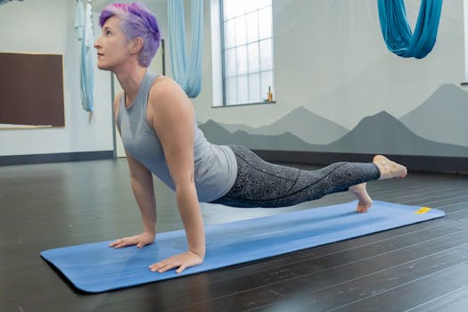 Woman performing yoga in a modern studio, showcasing fitness and focus with a serene backdrop.