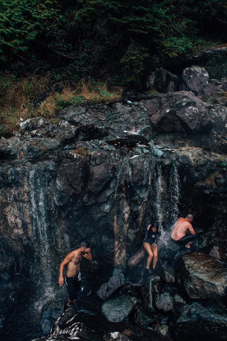 People Sitting On The Rocky River