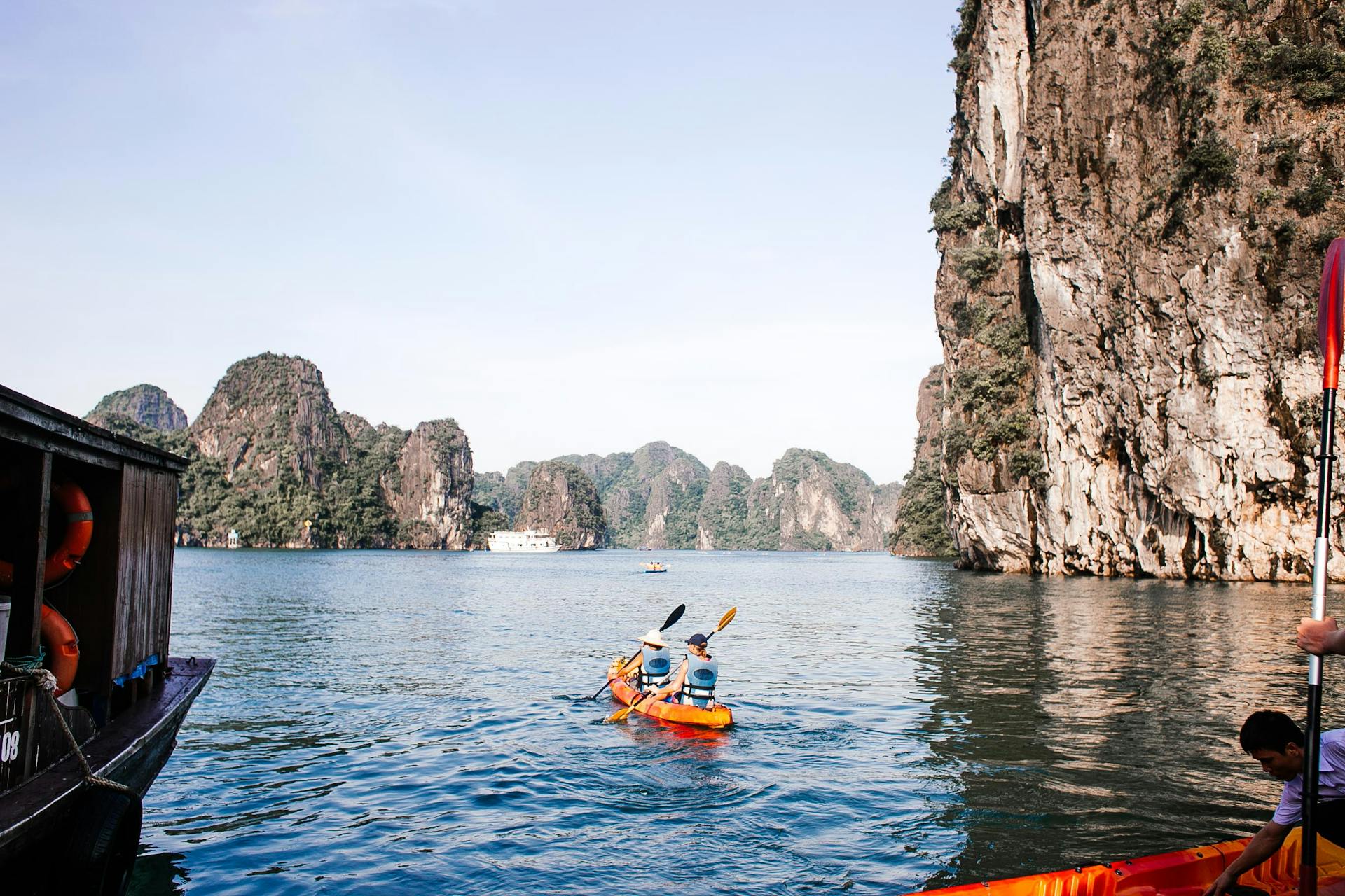 Two people kayaking in a breathtaking limestone bay, perfect for adventure and exploration.