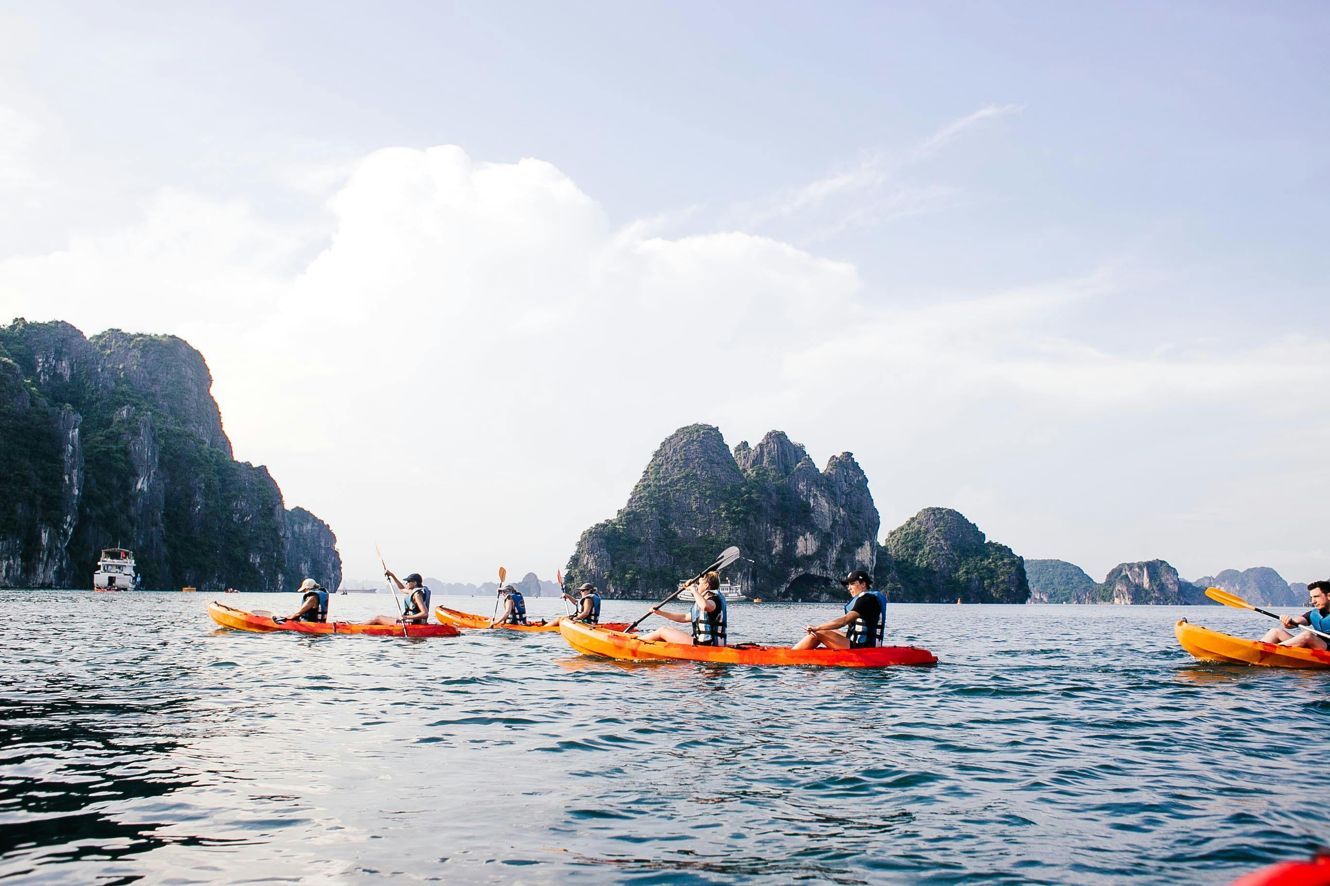 people kayaking in ha long bay in vietnam