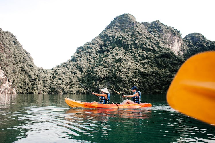 People Kayaking In Ha Long Bay In Vietnam 