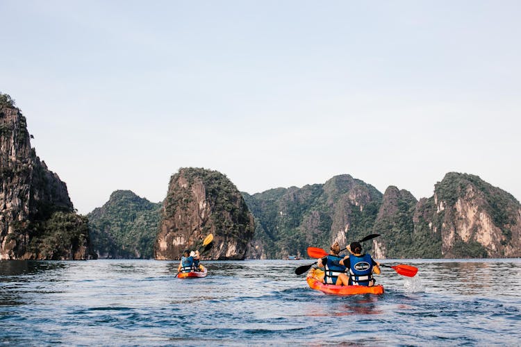 People Kayaking On Sea