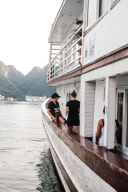 People enjoying a relaxing boat journey on a tranquil mountain lake.
