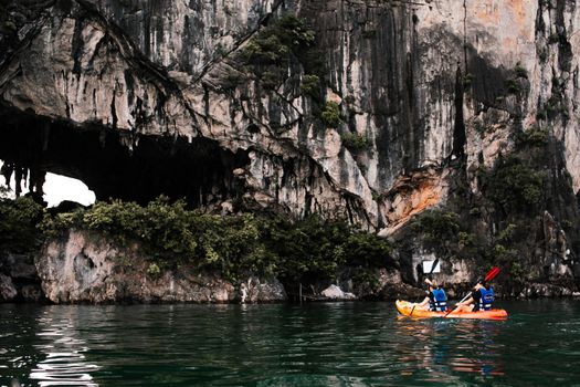 People Kayaking near a Limestone Karst