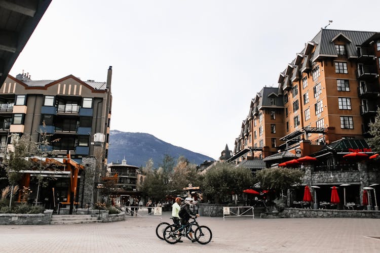 Bikers Walking With Their Bikes In Whistler Canada