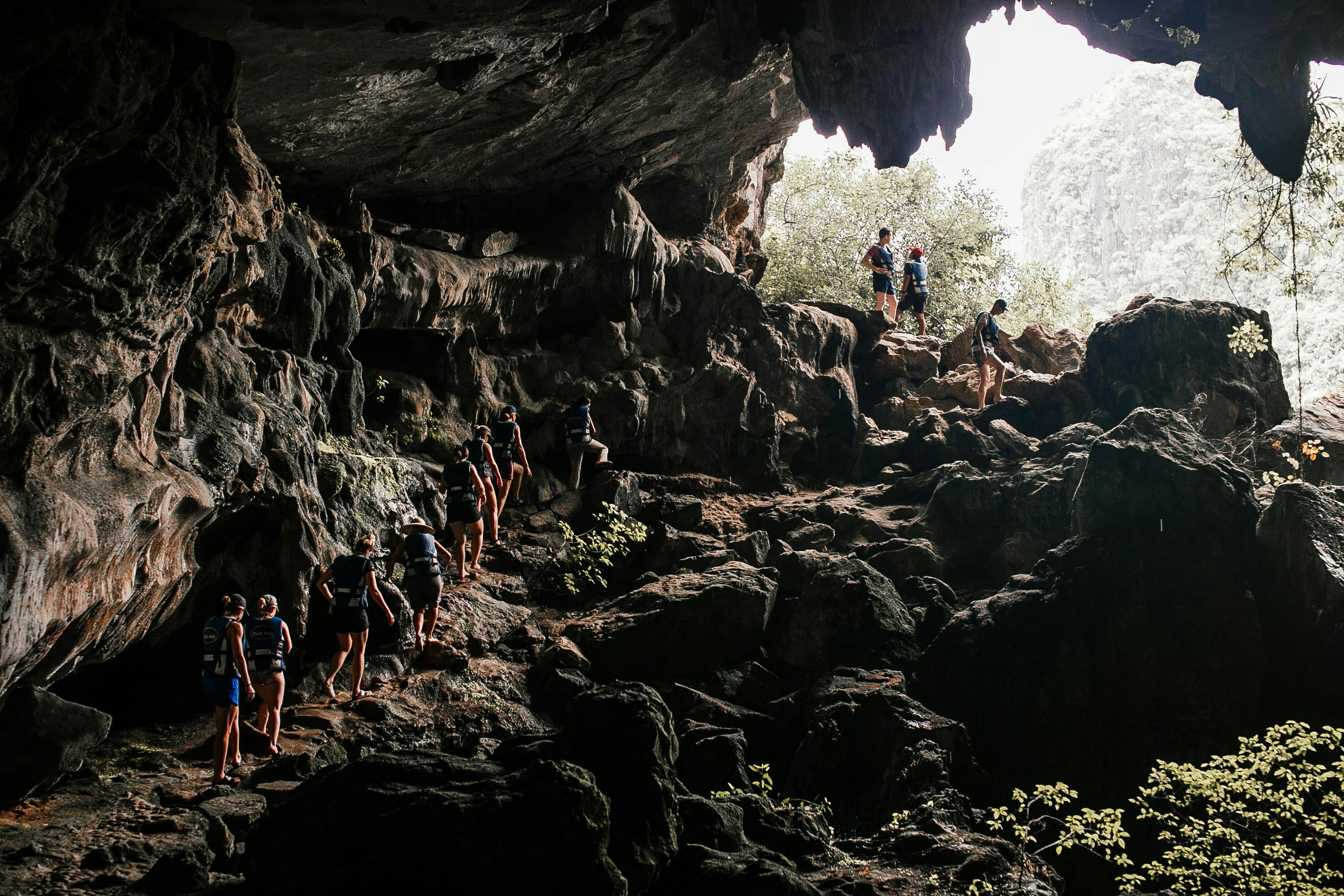 people walking in a cave