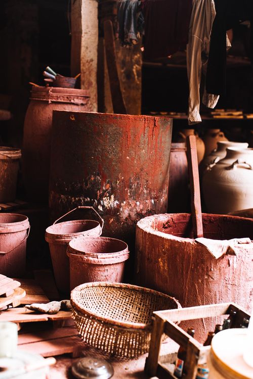Free A collection of rustic pottery equipment in an artisan's workshop. Warm tones and vintage feel. Stock Photo