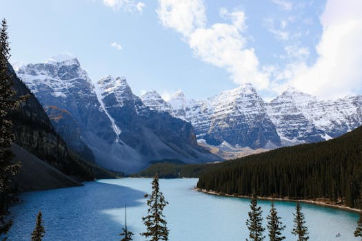 A stunning view of the Rocky Mountains with snow-covered peaks and a serene blue river.