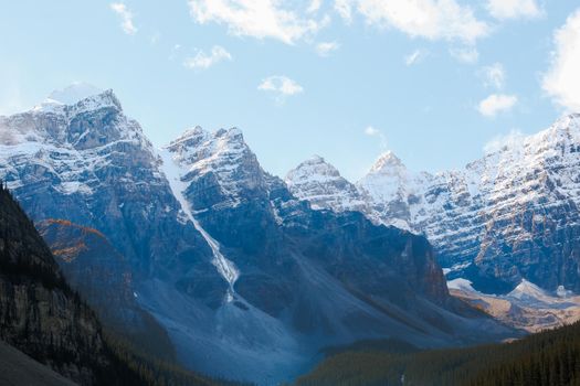 Stunning view of snow-capped Rocky Mountains under a clear blue sky in winter.