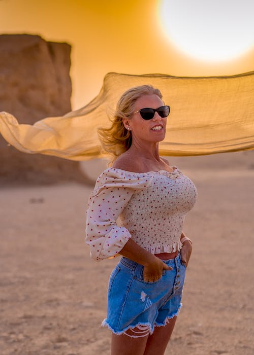 Stylish woman standing in desert