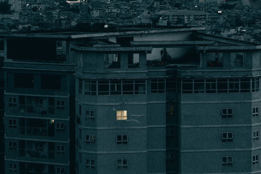 Aerial view of a dimly lit residential building at night in Ho Chi Minh City, Vietnam.