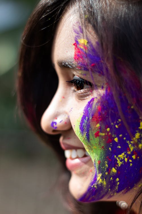 A Woman's Face Covered in Gulal