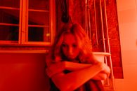 A Woman Sitting Beside the Bathtub
