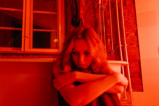 A Woman Sitting Beside the Bathtub
