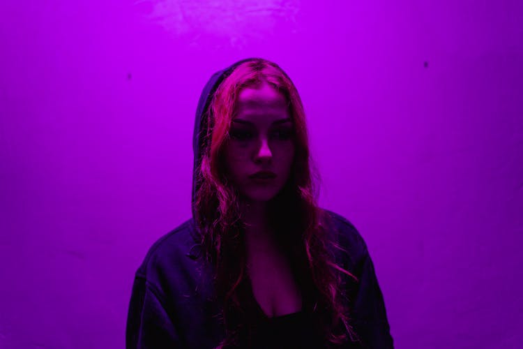 Woman In A Hoodie In Purple Light