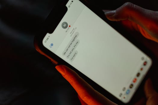 A close-up view of a text message on a smartphone screen displaying a breakup message.
