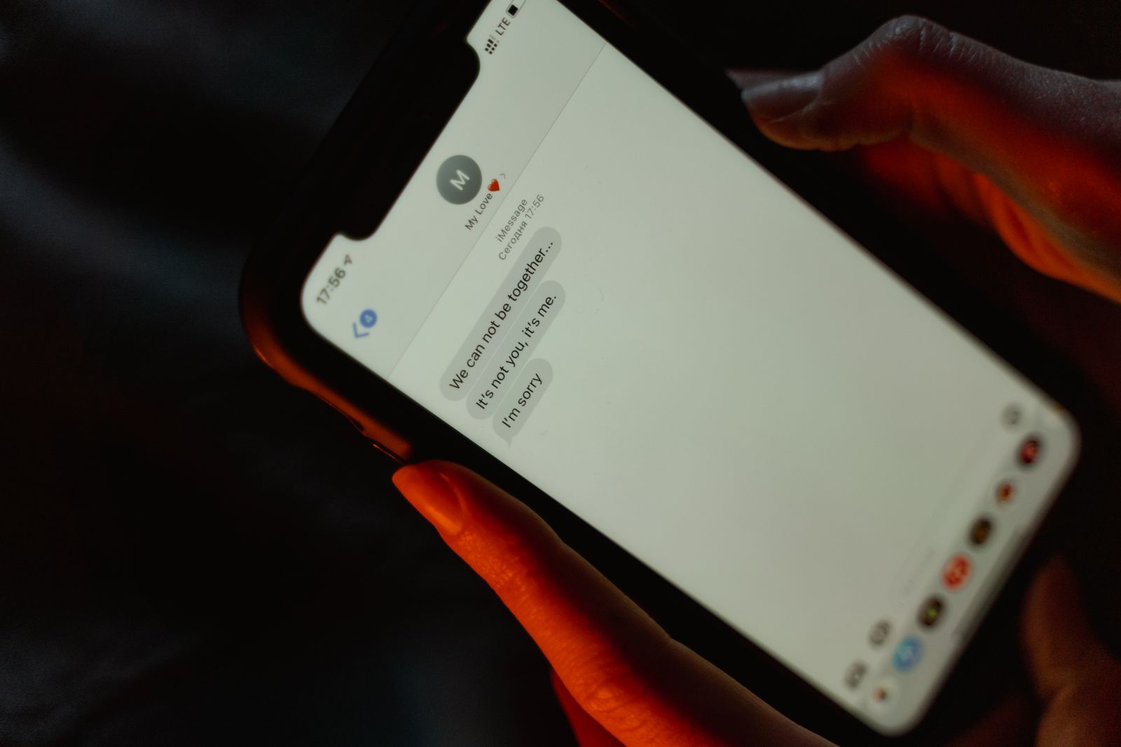 A person reading a text message on a smartphone screen