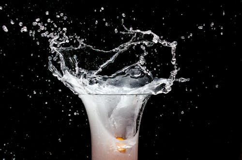 Free Close Up Shot of a Drinking Glass with White Liquid Inside Stock Photo