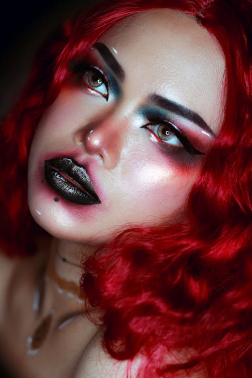 A Woman With Red Hair and Black Lipstick