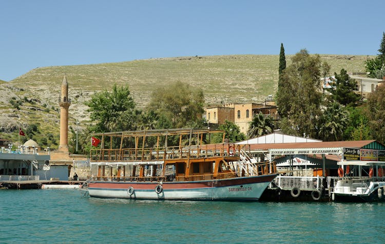 Vintage Boats Moored And Hill With A Minaret In Background