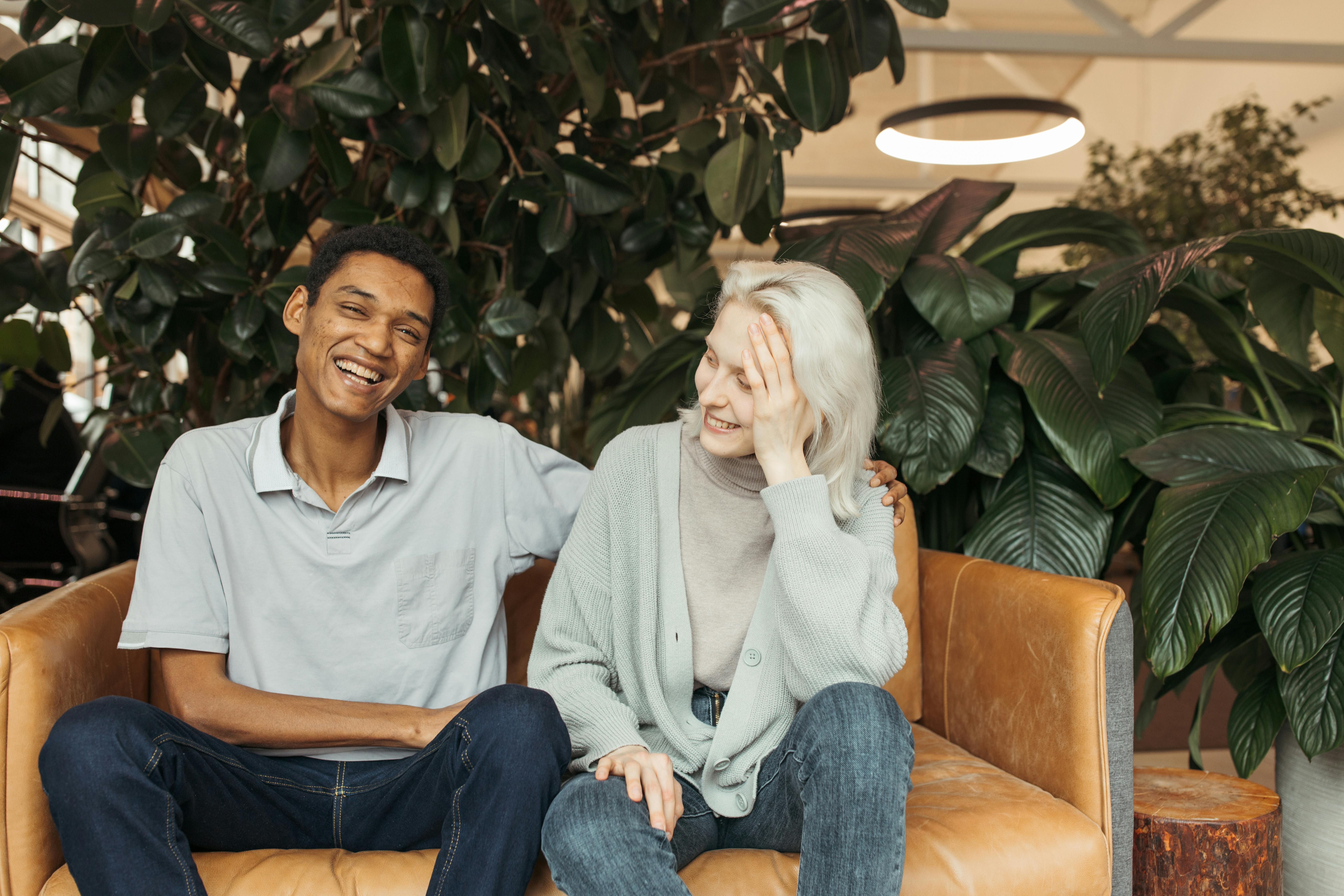 woman in white sweater sitting beside man in gray sweater