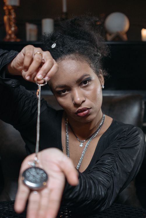 A Woman Holding a Locket · Free Stock Photo