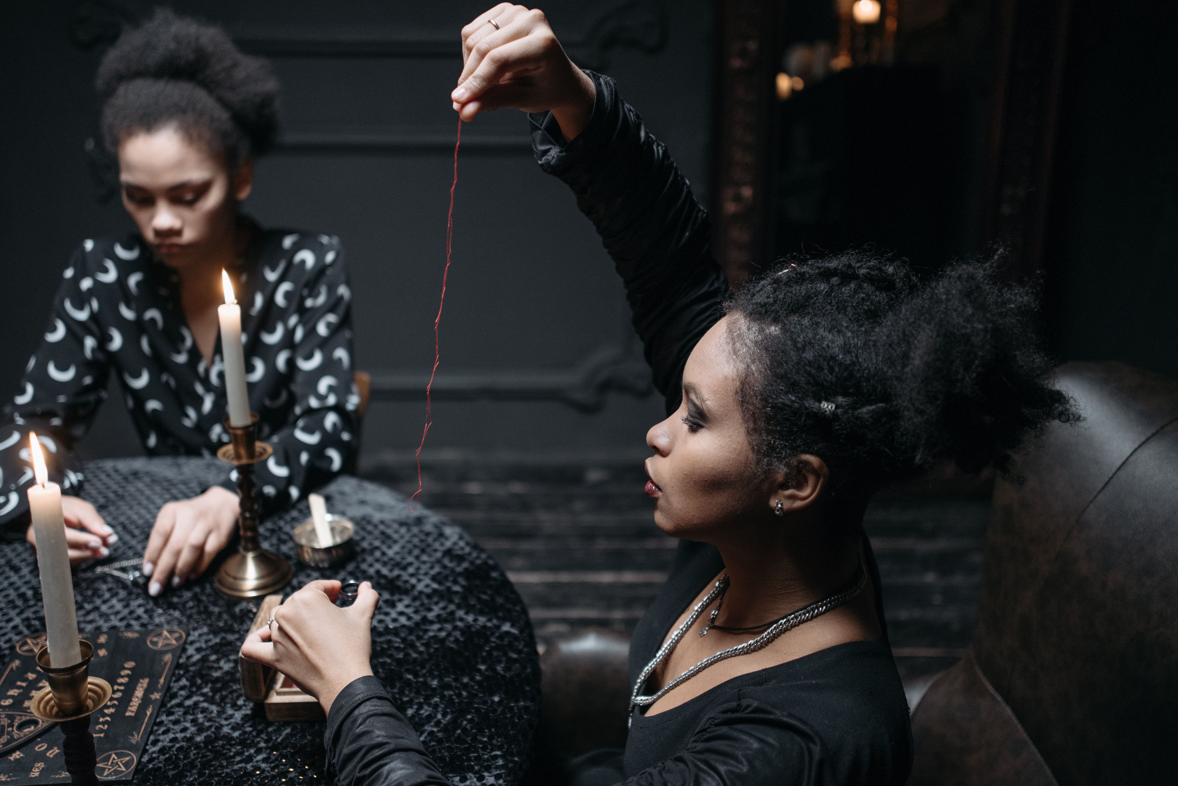A Woman Holding a Red Thread · Free Stock Photo
