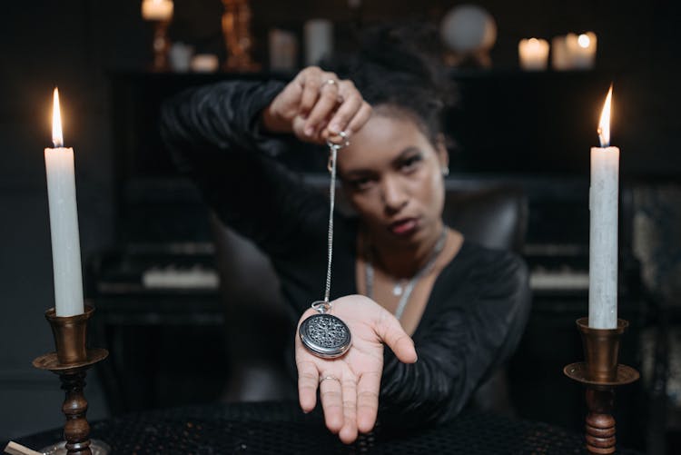 A Woman Holding A Locket