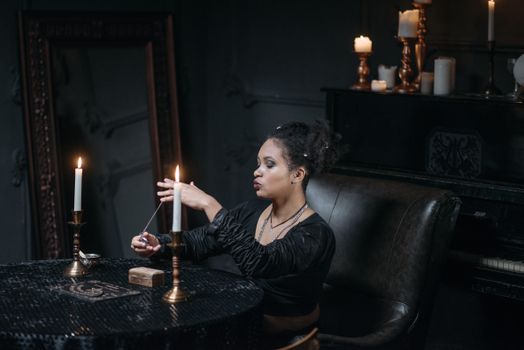 A Woman Sitting at the Table with Candles Holding a Pocket Watch