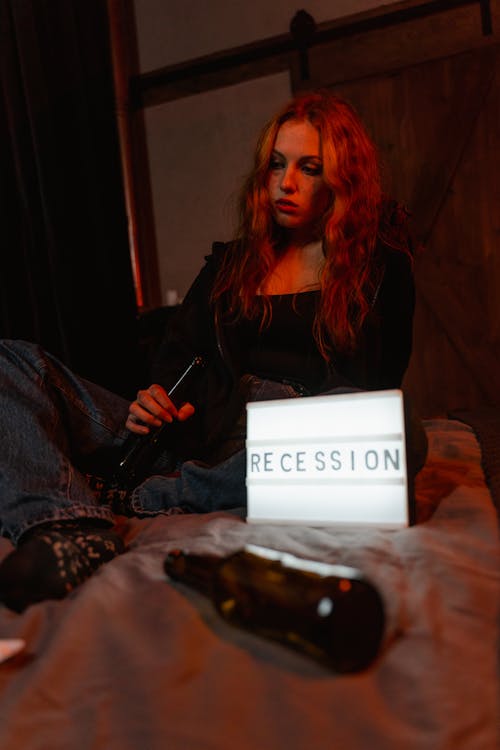 A Depressed Woman Holding a Beer Bottle