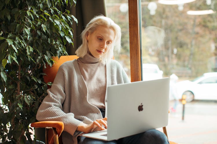 Woman In Gray Sweater Using MacBook