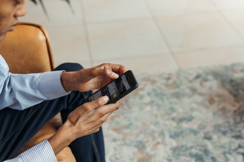 Free Close-up of a man using a smartphone indoors, showcasing modern lifestyle and technology. Stock Photo