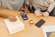 A Person Writing on White Notebook