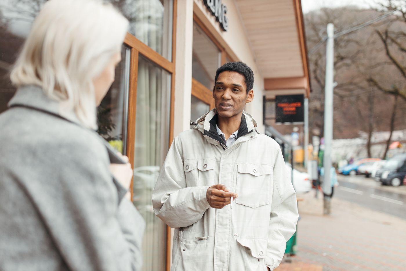 Two people talking on a cloudy street