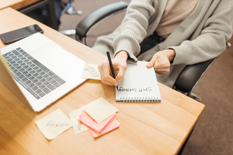 Person writing growth notes at a desk