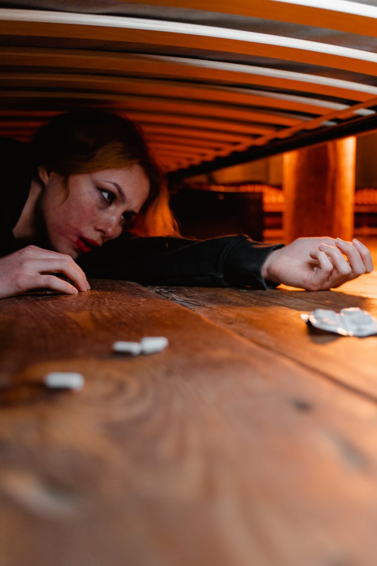 Hurt Woman Hiding Under The Bed