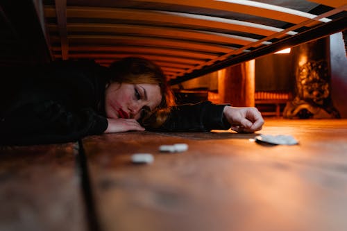 Free A Woman Hiding Under the Bed Stock Photo