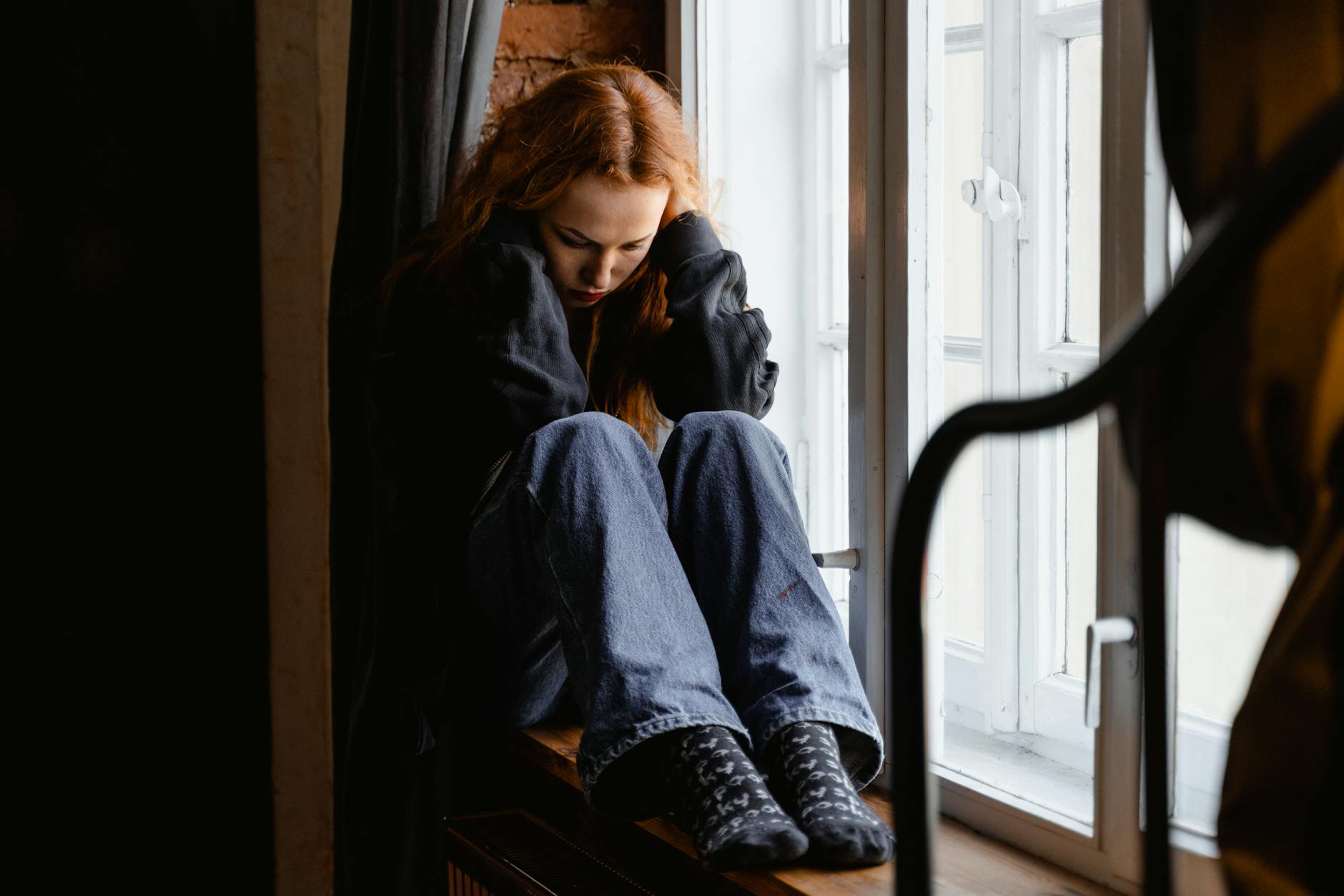 https://www.pexels.com/photo/depressed-woman-sitting-by-the-window-7279062/