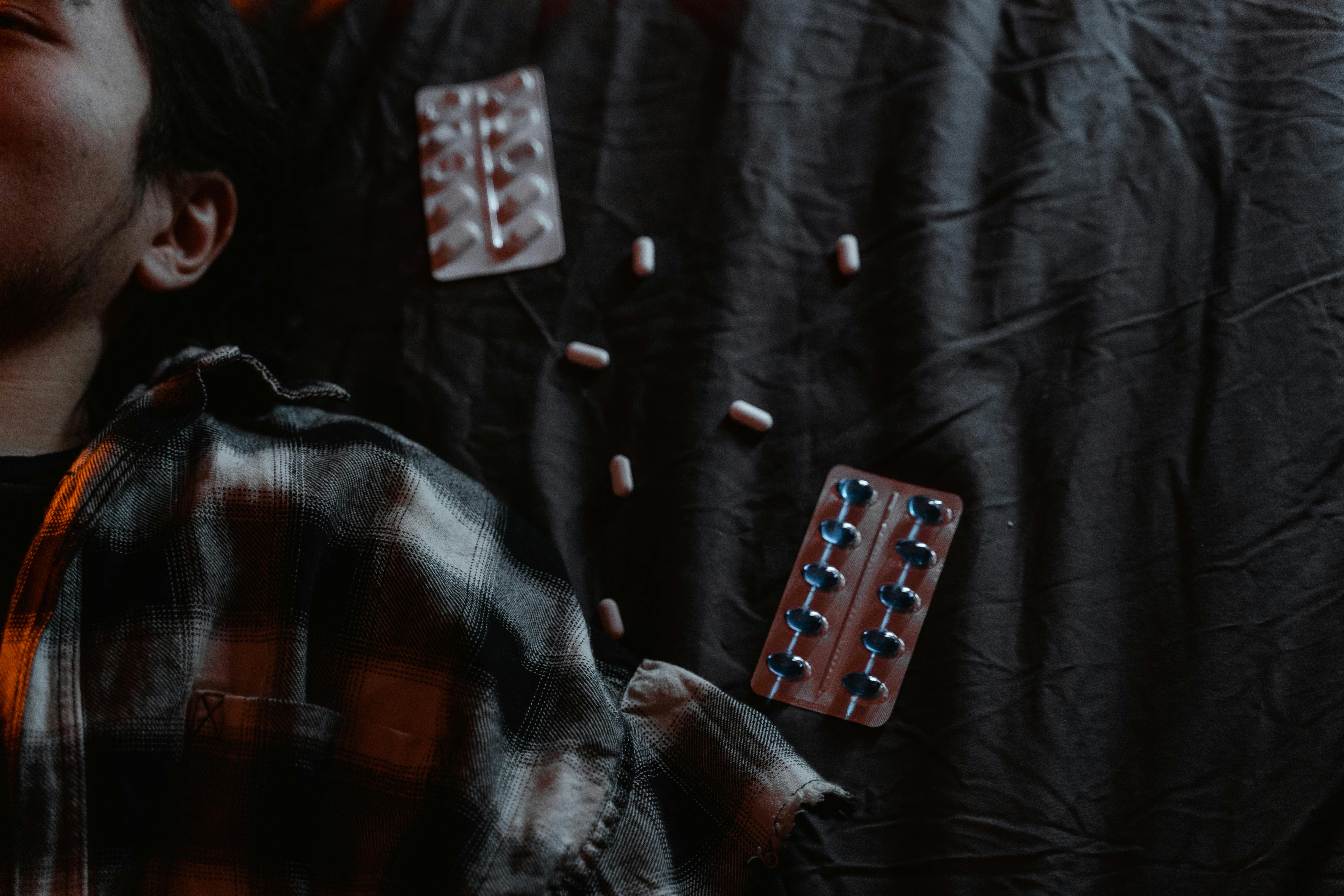 black and red textile with white and red medication pill