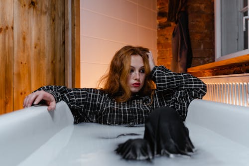 Depressed Woman Sitting in a Bathtub