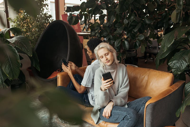 Why Gen Z Prefers Chatbots: What It Means for How We All Use AI 3 Two people on phones representing personalized AI experiences