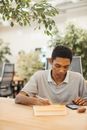Man Looking at Phone While Holding Pen