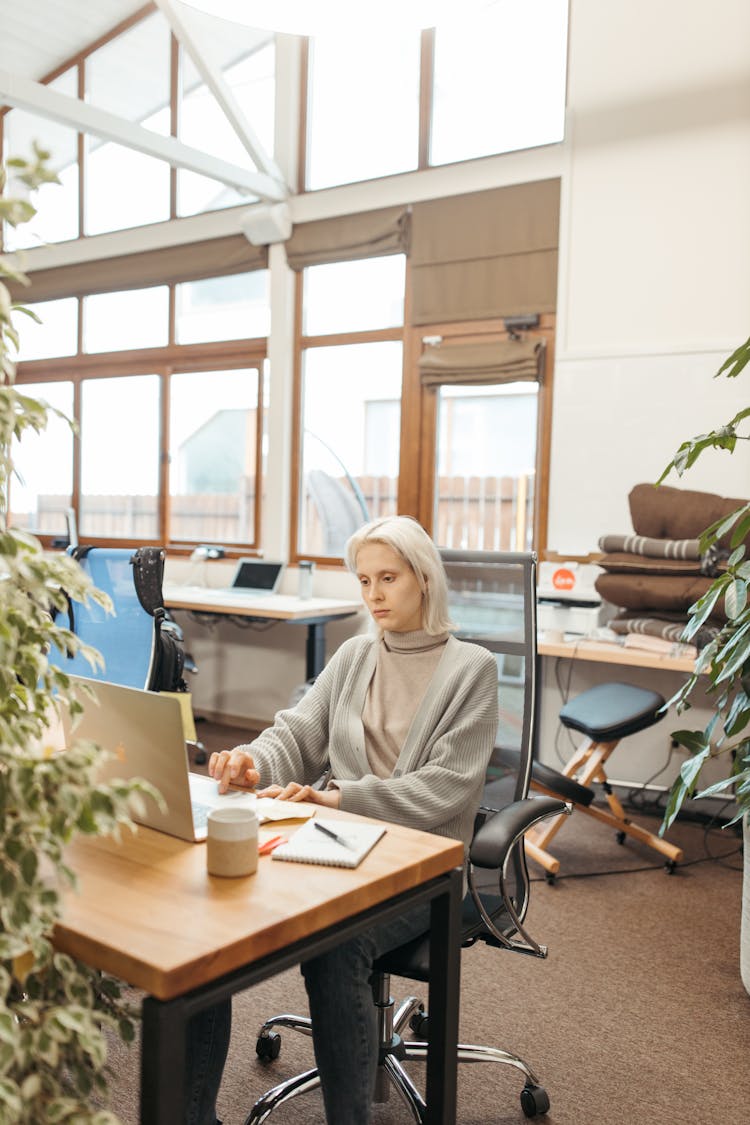 Woman Sitting On Black Office Rolling Chair