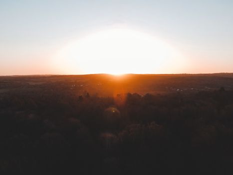 Experience the serene beauty of sunrise over the lush landscapes of England, capturing nature's tranquil colors.